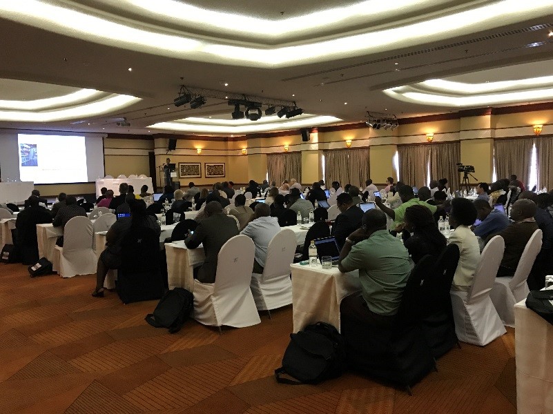 Participants of ICPP2 sitting in a hall watching a presentation